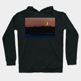 Crescent moon setting behind forest landscape Hoodie